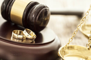 two wedding band rings and gavel divorce