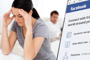 Woman with hands on head doing social media in divorce