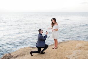 Couple on a beach getting engaged